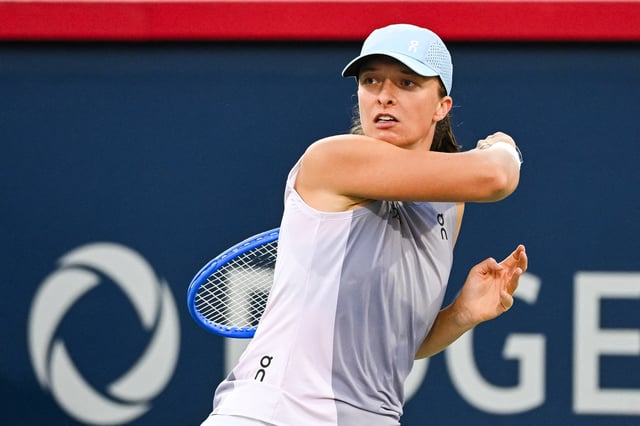 Aug 1, 2025; Montreal, QC, Canada; Iga Swiatek (POL) looks on against Eva Lys (GER) in third round play at IGA Stadium. Mandatory Credit: David Kirouac-Imagn Images