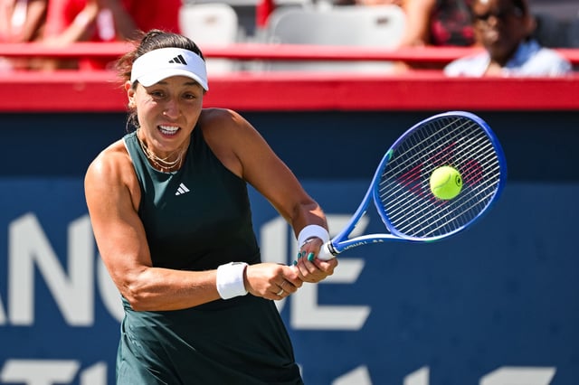 Aug 1, 2025; Montreal, QC, Canada; Jessica Pegula (USA) returns the ball to Anastasija Sevastova (LAT) in third round play at IGA Stadium. Mandatory Credit: David Kirouac-Imagn Images