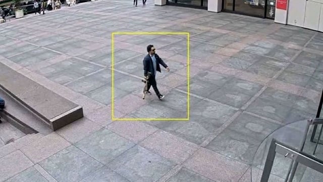 In an image obtained by CNN, Shane Devon Tamura is seen outside the 345 Park Avenue office building carrying a rifle.