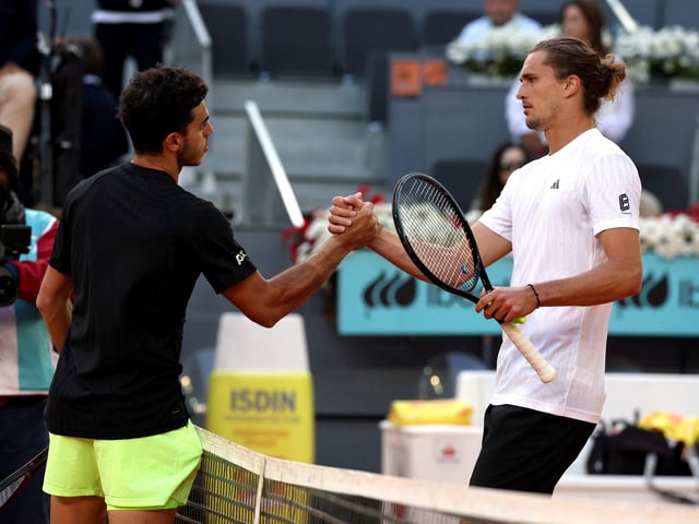 Tennis - Madrid Open - Park Manzanares, Madrid, Spain - April 29, 2025
Argentina's Francisco Cerundolo shakes hands with Germany's Alexander Zverev after winning his round of 16 match REUTERS/Violeta Santos Moura