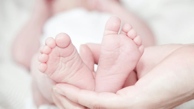 The infant was alone on the bed while her mother was cooking in another room at their home