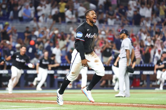 MIAMI, FLORIDA - AUGUST 01: Xavier Edwards #9 of the Miami Marlins celebrates after a walk off win against the New York Yankees at loanDepot park on August 01, 2025 in Miami, Florida.