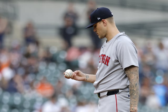 DETROIT, MI - MAY 12: Tanner Houck #89 of the Boston Red Sox checks a baseball after giving up a home run to Gleyber Torres of the Detroit Tigers during the first inning at Comerica Park on May 12, 2025 in Detroit, Michigan.