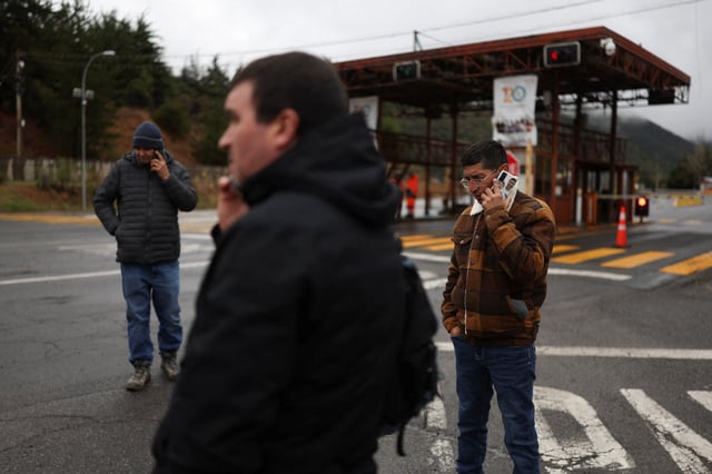 Contract workers wait at the access to the El Teniente copper mine complex after several miners have been reported missing at the Andesita unit following a seismic incident, in Maitenes, Chile, August 1, 2025. REUTERS/Pablo Sanhueza