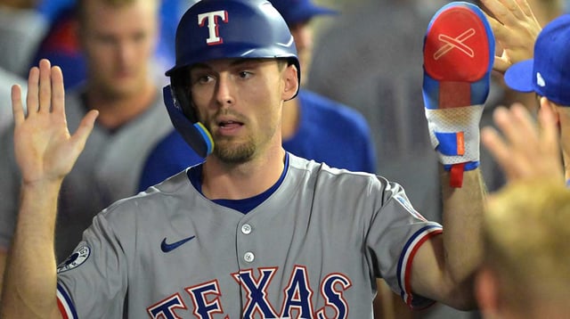 Jul 28, 2025; Anaheim, California, USA; Texas Rangers center fielder Evan Carter (32) in the dugout after scoring a run in the eighth inning against the Los Angeles Angels at Angel Stadium. Mandatory Credit: Jayne Kamin-Oncea-Imagn Images