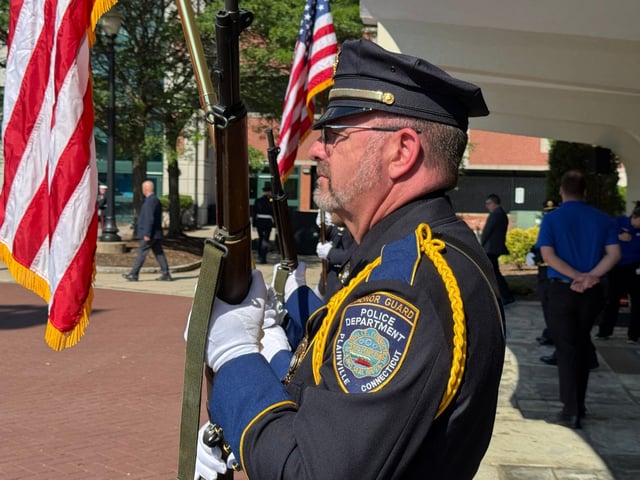 Plainville officer Shane Dufresne, a member of the town&#39;s Honor Guard, participates in a ceremony during the funeral of Plainville firefighter Raymond Moreau on Saturday in New Britain. (Photo/Credit Stephen Underwood)