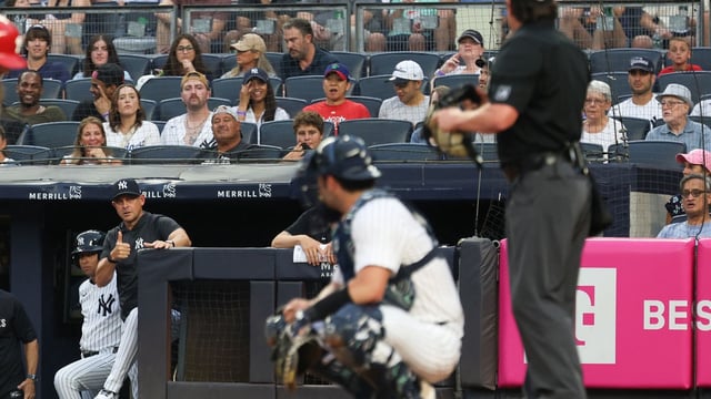 Jul 25, 2025; Bronx, New York, USA; New York Yankees manager Aaron Boone (17) talks with umpire DJ Reyburn (17) during the second inning against the Philadelphia Phillies at Yankee Stadium. Mandatory Credit: Vincent Carchietta-Imagn Images.