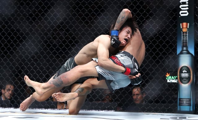 Tatsuro Taira (L) takes down Edgar Chairez in a 130-pound catchweight bout during UFC 290 at T-Mobile Arena on July 08, 2023 in Las Vegas, Nevada. Taira won the bout by unanimous decision.