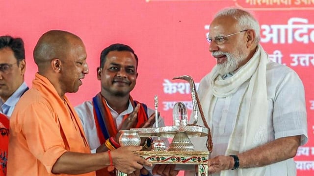 Chief minister Yogi Adityanath presents a handcrafted Shivling to Prime Minister Narendra Modi in Varanasi on Saturday. (ANI PHOTO)