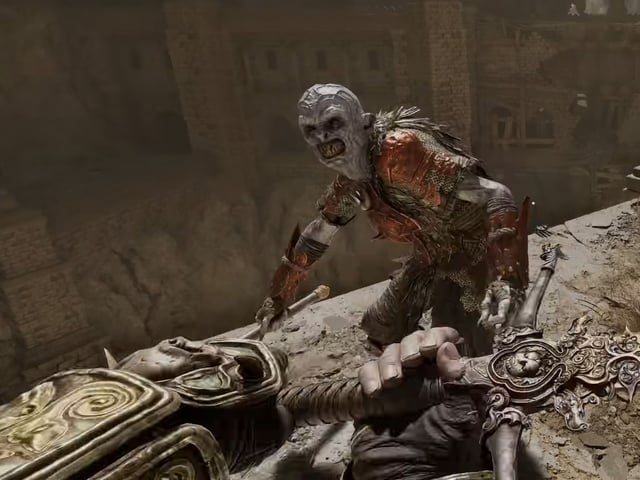 Swinging a sword at a gray-skinned monster standing too close to a sheer drop