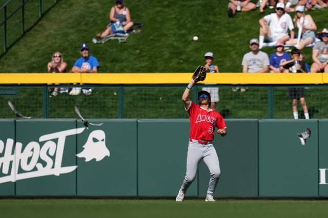 Angels center fielder Bryce Teodosio battles the sun and flying pigeons to make a catch on a fly ball hit by Chicago Cubs’ Kyle Tucker during the sixth inning of a spring training baseball game Thursday, Feb. 27, 2025, in Mesa, Ariz. (AP Photo/Ross D. Franklin)