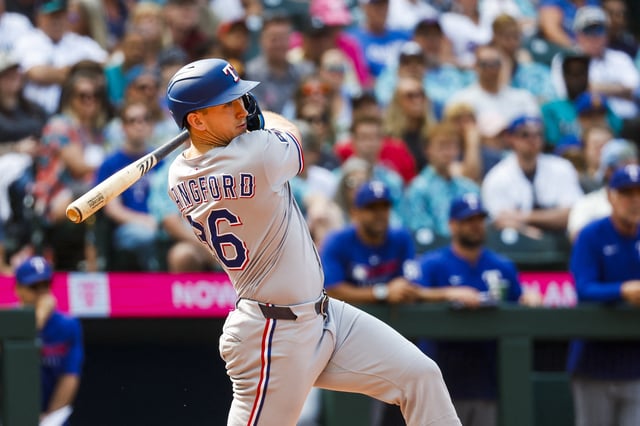 Aug 2, 2025; Seattle, Washington, USA; Texas Rangers center fielder Wyatt Langford (36) hits an RBI-single against the Seattle Mariners during the eleventh inning at T-Mobile Park. Mandatory Credit: Joe Nicholson-Imagn Images