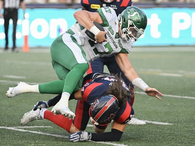 Montreal Alouettes' Marc-Antoine Dequoy, bottom, tries to stop Saskatchewan Roughriders quarterback Tommy Stevens (17) as he runs for yardage during first half CFL football action in Montreal, Saturday, Aug. 2, 2025.