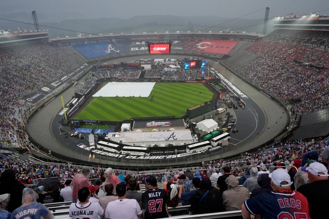 The field is covered up during a rain delay at the MLB Speedway Classic between the Braves and the Reds at Bristol Motor Speedway on Saturday, Aug. 2, 2025, in Bristol, Tenn. (AP Photo/George Walker IV)