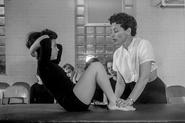 Bonnie Prudden, Director of the Institute of Physical Fitness, helps a student in the second Kraus Weber test in 1955 in White Plains, N.Y.