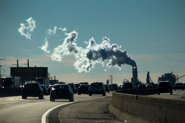 Vehicles move along the The New Jersey Turnpike Way while a Factory emits smoke on November 17, 2017 in Carteret, New Jersey.