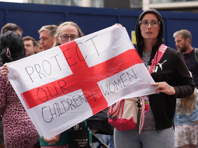 People during a protest near the Britannia International Hotel in Canary Wharf, London where asylum seekers are planned to be housed. Picture date: Sunday August 3, 2025. (Photo by Lucy North/PA Images via Getty Images)