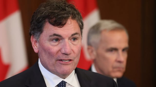 President of the King’s Privy Council for Canada Dominic LeBlanc speaks at a press conference while Prime Minister Mark Carney listens, on Parliament Hill in Ottawa, Thursday, June 19, 2025.