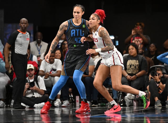 Brittney Griner #42 of the Atlanta Dream and Shakira Austin #0 of the Washington Mystics look on during the fourth quarter at Gateway Center Arena on June 20, 2025 in College Park, Georgia.