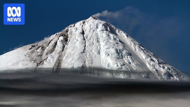 Snow covered volcanic mountain peak.