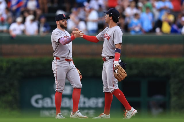 CHICAGO, ILLINOIS - JULY 20: Trevor Story #10 and Marcelo Mayer #39 of the Boston Red Sox celebrate their team&#39;s win over the Chicago Cubs at Wrigley Field on July 20, 2025 in Chicago, Illinois.