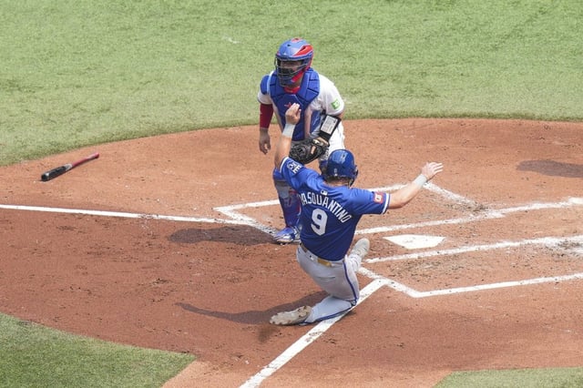 Kansas City Royals first base Vinnie Pasquantino (9) scores in front Toronto Blue Jays catcher Alejandro Kirk after a sacrifice fly from Royals' Mike Yastrzemski during fourth inning MLB baseball action in Toronto on Sunday August 3, 2025. THE CANADIAN PRESS/Chris Young
