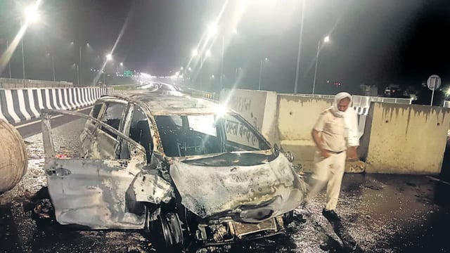 Burnt remains of the Ertiga taxi after the accident. (HT Photo)
