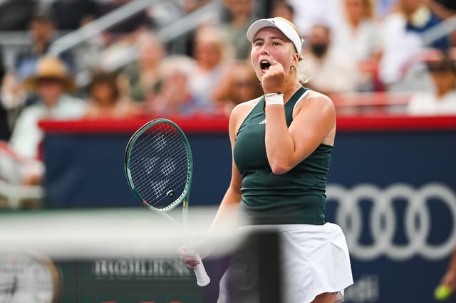 Aug 3, 2025; Montreal, QC, Canada; Clara Tauson (DEN) reacts after winning a point against Iga Swiatek (POL) in fourth round play at IGA Stadium. Mandatory Credit: David Kirouac-Imagn Images