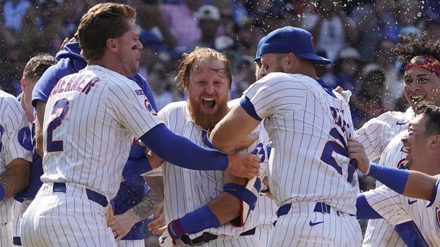 Aug 3, 2025; Chicago, Illinois, USA; Chicago Cubs pinch hitter Justin Turner (center) celebrates his two-run game winning home run against the Baltimore Orioles with his teammates during the ninth inning at Wrigley Field. Mandatory Credit: David Banks-Imagn Images