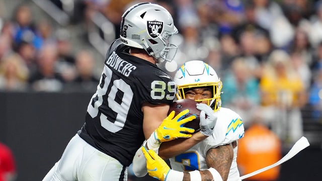 Las Vegas Raiders tight end Brock Bowers (89) and Los Angeles Chargers safety Derwin James Jr. (3) reach for a pass during the fourth quarter at Allegiant Stadium. Mandatory Credit: Stephen R. Sylvanie-Imagn Images