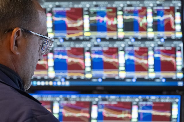 A Trader works on the floor of the New York Stock Exchange, Friday, Aug. 1, 2025, in New York. (AP Photo/Yuki Iwamura)