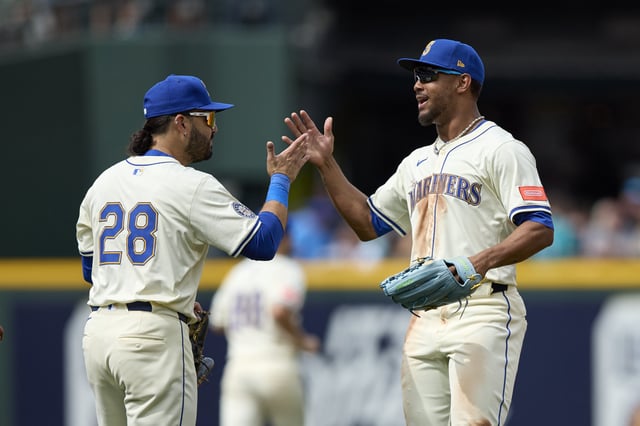 Aug 3, 2025; Seattle, Washington, USA; Seattle Mariners third baseman Eugenio Suarez (28) greets Seattle Mariners center fielder Julio Rodríguez (44) after playing the Texas Rangers at T-Mobile Park. Mandatory Credit: John Froschauer-Imagn Images