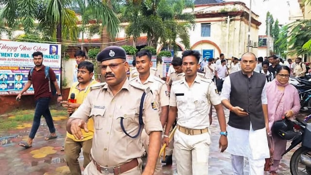 Police personnel investigate after a female student allegedly set herself on fire over sexual harassment at Fakir Mohan (Autonomous) College, in Balasore district, Odisha, Saturday, July 12, 2025.
