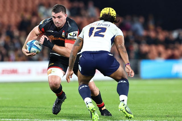 HAMILTON, NEW ZEALAND - MAY 24: Simon Parker of the Chiefs is challenged by Danny Toala of Moana Pasifika during the round 15 Super Rugby Pacific match between Chiefs and Moana Pasifika at FMG Stadium, on May 24, 2025, in Hamilton, New Zealand. (Photo by Dave Rowland/Getty Images)