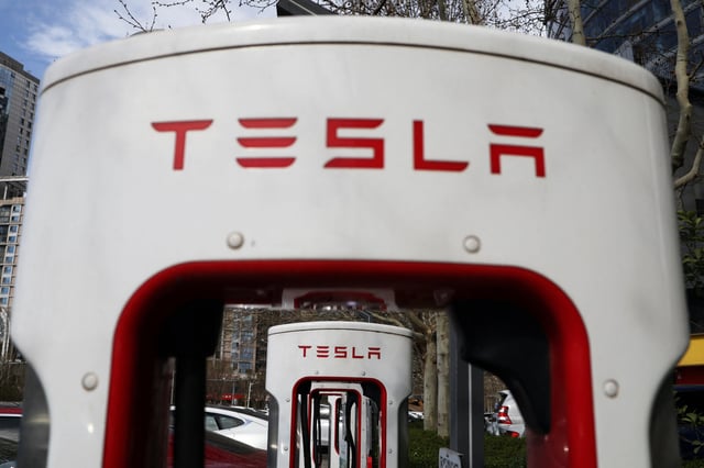 Tesla cars charge at a Supercharger charging station of the electric vehicle (EV) maker in Beijing, China March 24, 2025. REUTERS/Florence Lo/File Photo