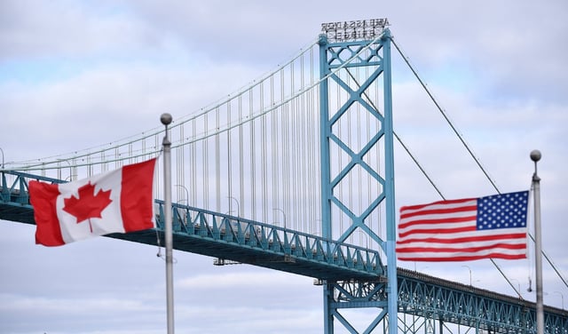 Bank of Canada governor Tiff Macklem said this week that the economy is showing "some resilience" to U.S. tariffs. Canadian and American flags fly near the Ambassador Bridge at the Canada-USA border crossing in Windsor, Ont. on Saturday, March 21, 2020. THE CANADIAN PRESS/Rob Gurdebeke