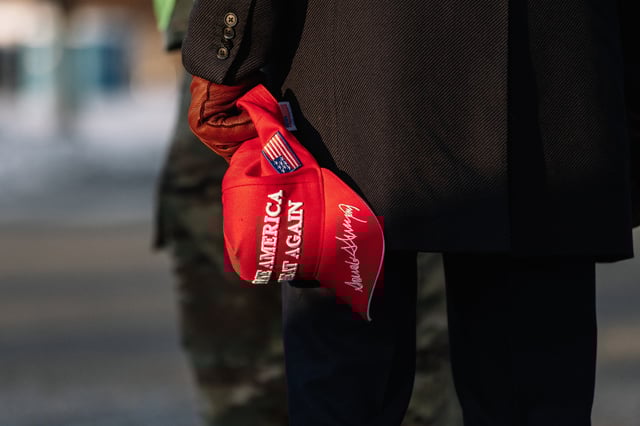 A Pro-Trump supporter holding a MAGA hat stands outside of the United States Capitol before the inauguration of the 47th President of the United States of America,