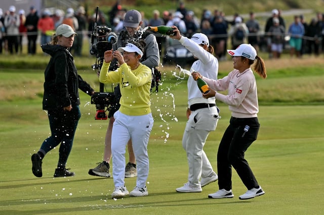 Yamashita is sprayed with champagne by fellow competitors after winning on Sunday.