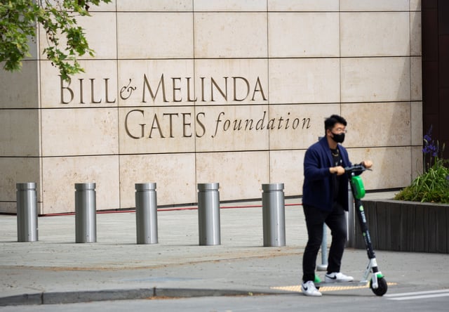 A person passes by on a scooter in front of the Bill & Melinda Gates Foundation in Seattle, Washington, U.S. May 5, 2021.  REUTERS/Lindsey Wasson/ File Photo