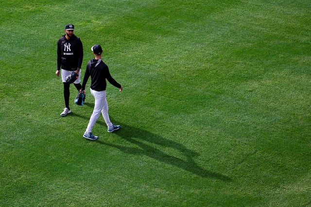 NEW YORK, NY - APRIL 14: Devin Williams #38 and Luke Weaver #30 of the New York Yankees talk before the game against the Kansas City Royals at Yankee Stadium on April 14, 2025 in New York, New York.