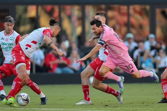 Inter Miami CF forward Lionel Messi (10) goes down after dribbling the ball against Necaxa defender Alexis Pena (4) and midfielder Raul Sanchez (11) during the first half of a Leagues Cup group stage match at Chase Stadium on Aug. 2, 2025.