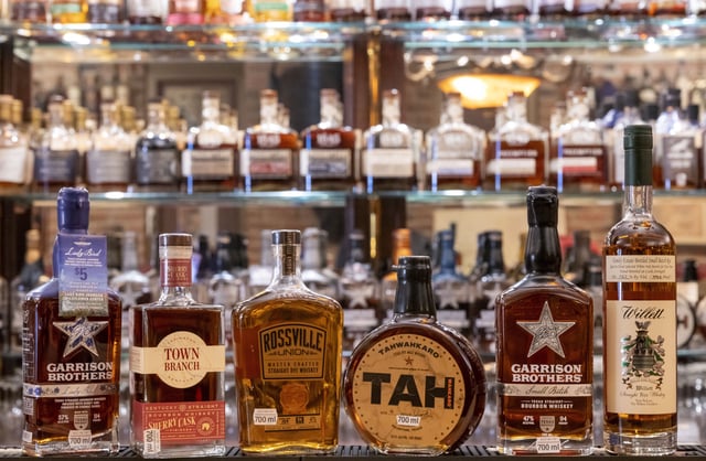 Bottles of whiskey sit on a shelf at whiskey store, March, 15, 2025.