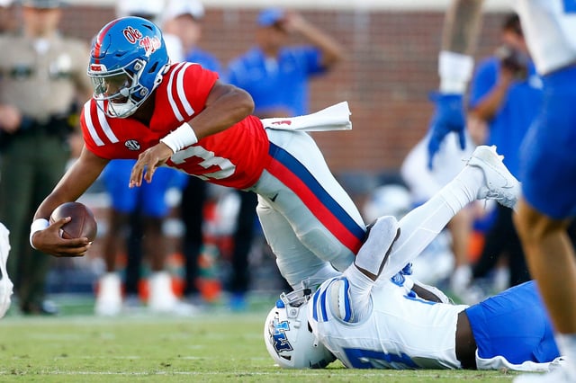 Mississippi quarterback Austin Simmons (13) dives forward as he is tackled by Middle Tennessee defensive back Rickey Smith (27) during the second half at Vaught-Hemingway Stadium.