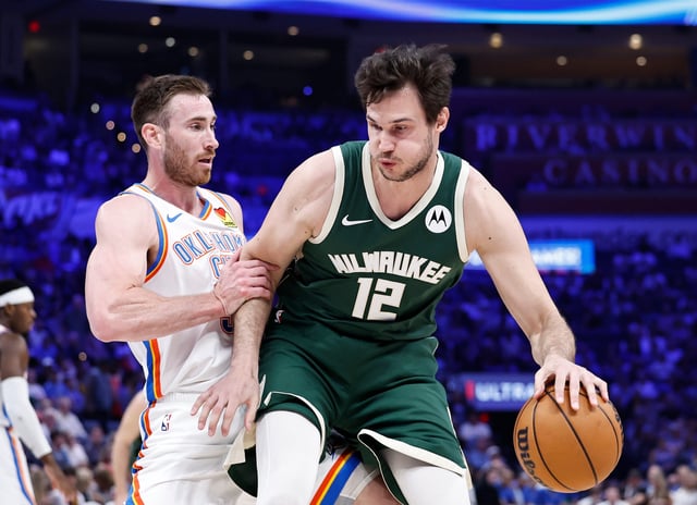 Apr 12, 2024; Oklahoma City, Oklahoma, USA; Milwaukee Bucks forward Danilo Gallinari (12) is defended by Oklahoma City Thunder guard Cason Wallace (22) during the second quarter at Paycom Center. Mandatory Credit: Alonzo Adams-USA TODAY Sports