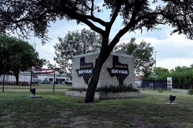 A tree shades the entrance to the Federal Prison Camp in Bryan, Texas, on Friday.