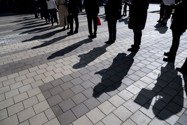 Job seekers wait in line to enter a job fair event in Silver Spring, Maryland, on April 16th. (Photo by ROBERTO SCHMIDT / AFP) (Photo by ROBERTO SCHMIDT/AFP via Getty Images)