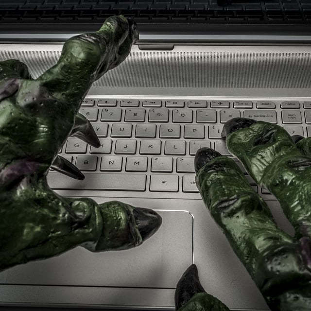 Monster hands typing on keyboard