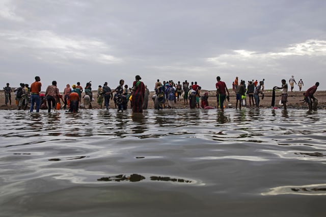 FILE - Ethiopian migrants walk on the shores of Ras al-Ara, Lahj, Yemen, after disembarking from a boat, July 26, 2019. (AP Photo/Nariman El-Mofty, File)