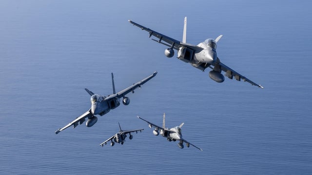 A formation of Air Test and Evaluation Squadron (VX) 31 “Dust Devils” aircraft, including an EA-18G Growler, AV-8B Harrier II+, an F/A-18E Super Hornet, and an F/A-18D Hornet, flies over Point Mugu’s Sea Range in Californati during a photo exercise. (Image credit: U.S. Navy)