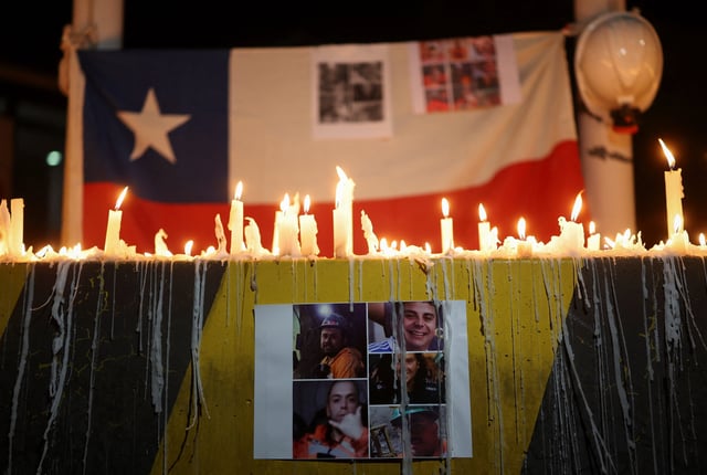 A print showing photos of miners who were trapped in the El Teniente mine complex, operated by Chilean state-run copper producer Codelco, in Maitenes, Chile, August 2, 2025. REUTERS/Pablo Sanhueza